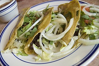 Barbacoa (beef) tacos with onions and cilantro.